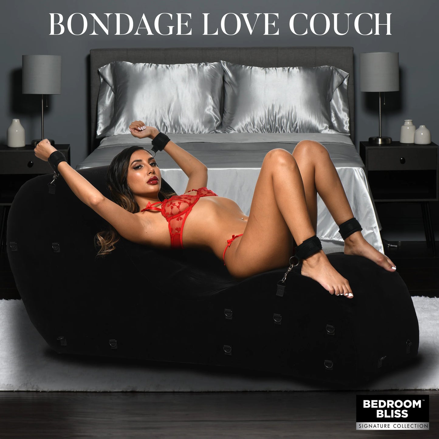 A person lays on the black bondage love couch with their ankles and wrists in cuffs, bound to the love couch underneath them. | Kinkly Shop